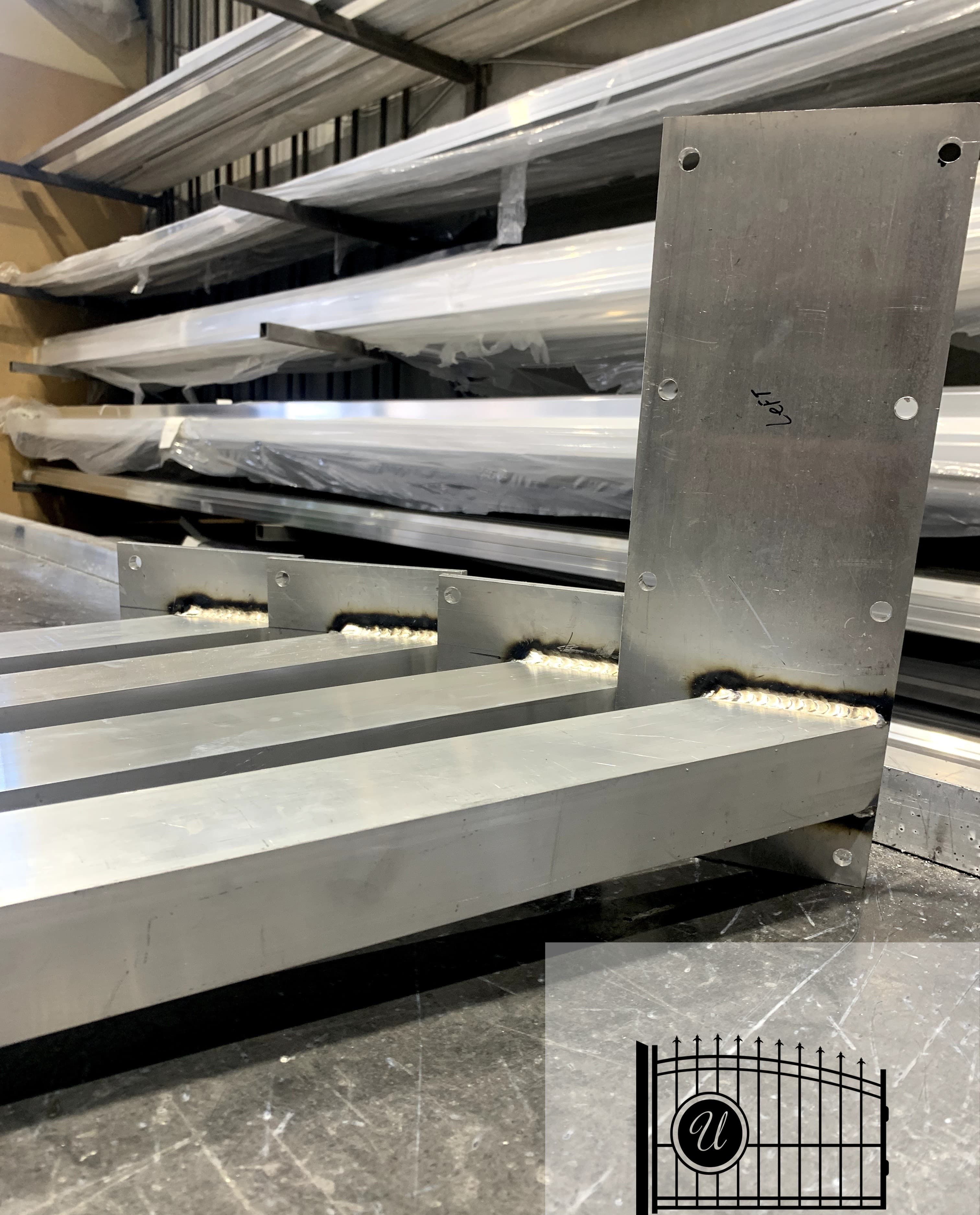 Aluminum extrusion stock on racks in our Surrey fabrication shop