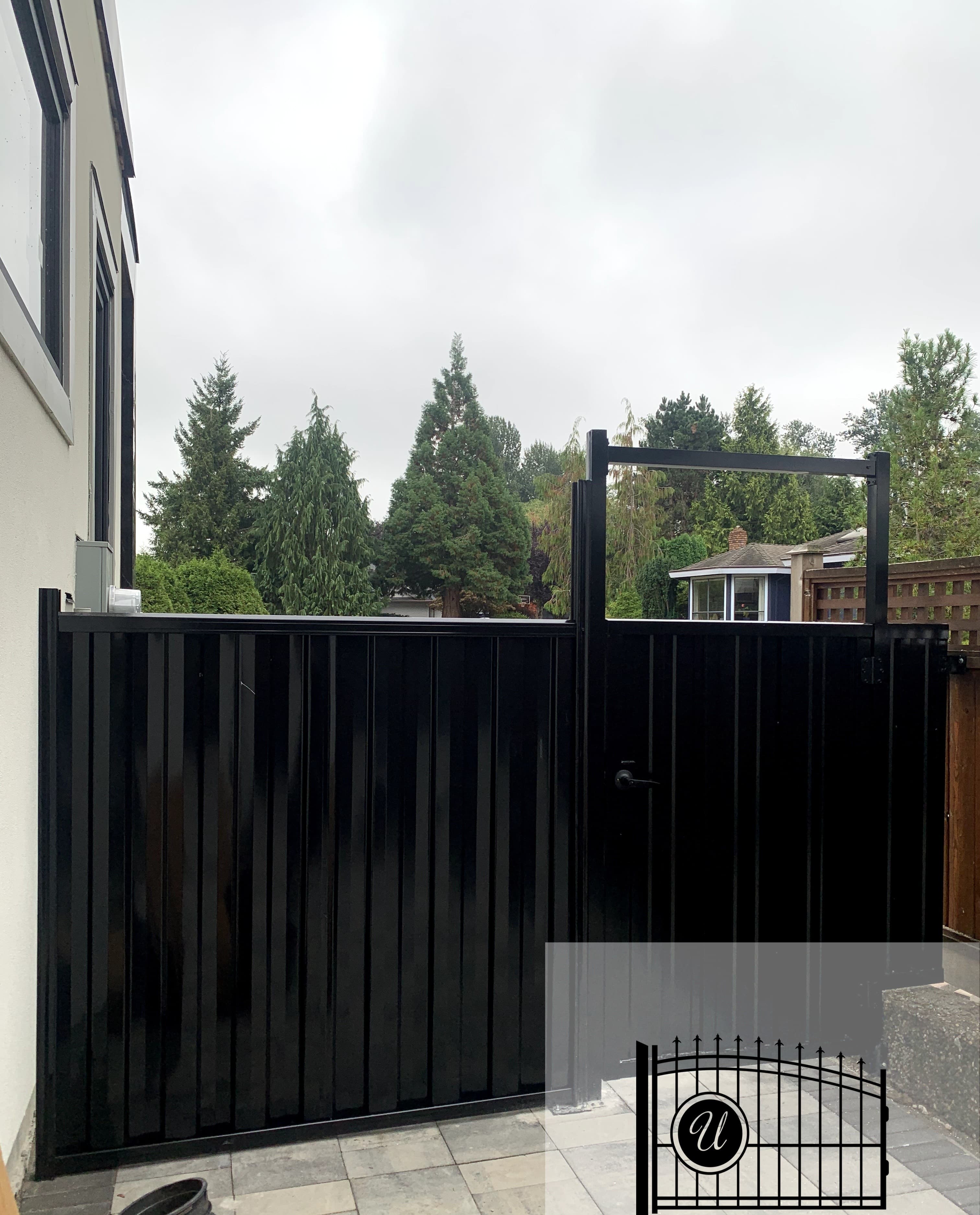 Modern black vertical-slat side-yard gate